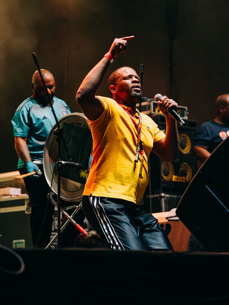 Performer in a yellow shirt on stage